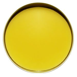 Top view of a round silver tin filled with a smooth bright yellow lotion bar.